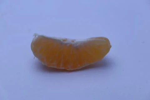 Slice of orange with white background Stock Photos