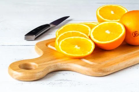 Slice of orange on wooden table Stock Photos