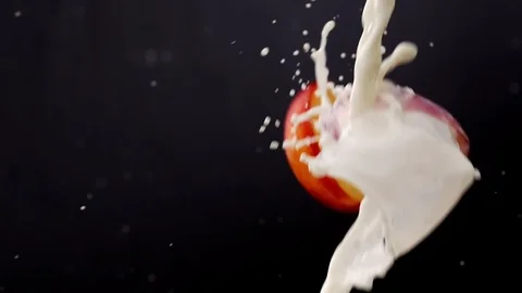Slice of Peaches Splashing into Milk Stock Footage 108308512