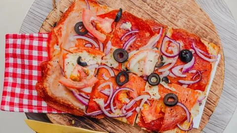 Slice of pepperoni pizza in hand isolated on white. Top view on paperoni pi.. Stock Photos