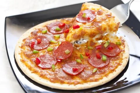Slice of pepperoni pizza Stock Photos