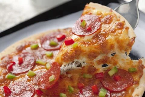 Slice of pepperoni pizza Stock Photos