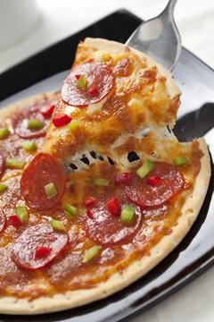Slice of pepperoni pizza Stock Photos