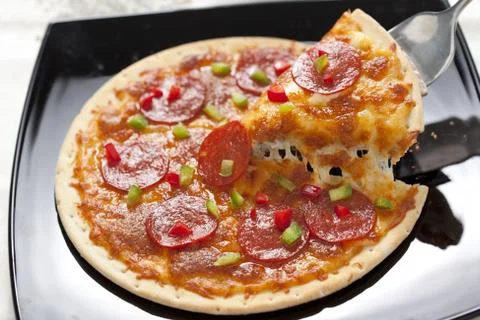 Slice of pepperoni pizza Stock Photos