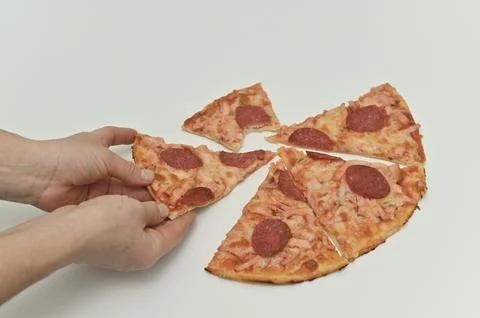 Slice of pepperoni pizza is pulled apart, with gooey cheese stretching betw.. Stock Photos
