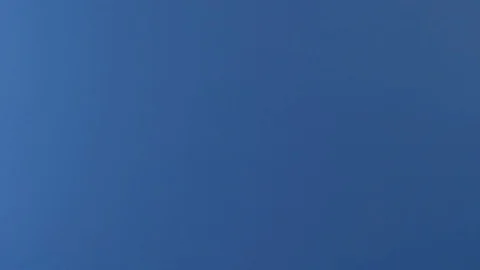 A slice of pepperoni pizza is seen flying in front of a blue screen. Video stock 126685055