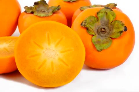 Slice persimmon fruit on white background Stock Photos