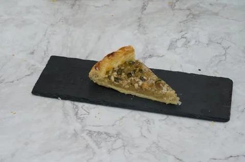 A slice of pie is on a black plate 스톡 사진