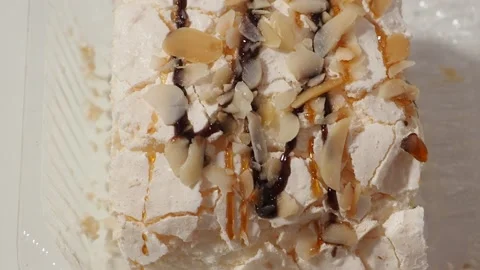 Slice piece of vanilla cake topping with white chocolate chips for coffee or tea 库存影片 145303835
