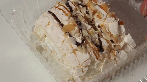Slice piece of vanilla cake topping with white chocolate chips for coffee or tea 库存影片 145303853