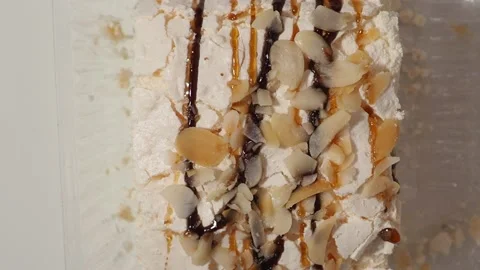 Slice piece of vanilla cake topping with white chocolate chips for coffee or tea Stockbeeldmateriaal 145303869