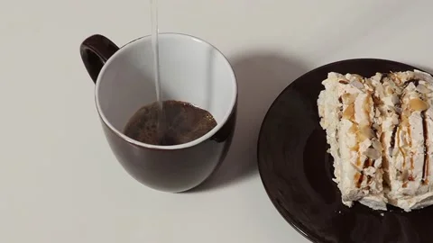 Slice piece of vanilla cake topping with white chocolate chips for coffee or tea 库存影片 145303905