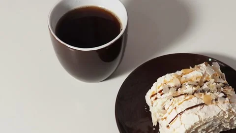 Slice piece of vanilla cake topping with white chocolate chips for coffee or tea 库存影片 145303942