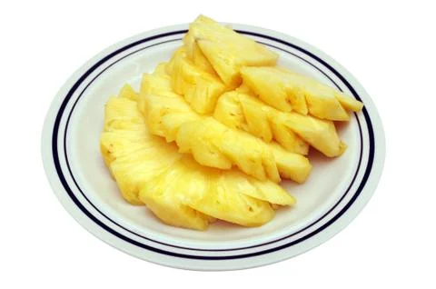 Slice of pineapple on dish isolated on white Stock Photos