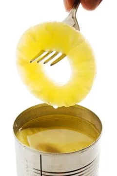 Slice of pineapple on a fork Stock Photos