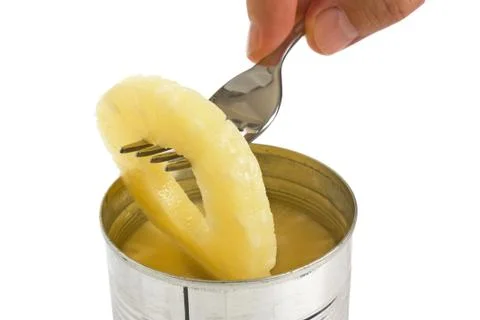 Slice of pineapple on a fork Stock Photos