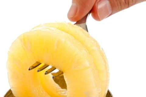 Slice of pineapple on a fork Stock Photos