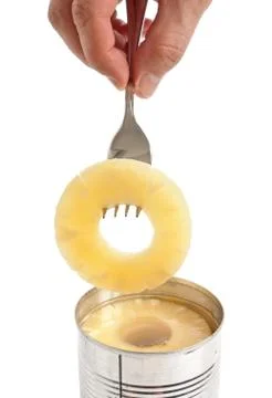 Slice of pineapple on a fork Stock Photos