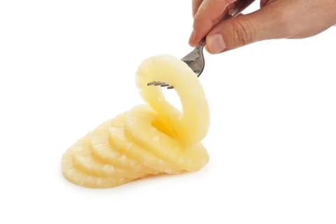 Slice of pineapple on a fork Stock Photos