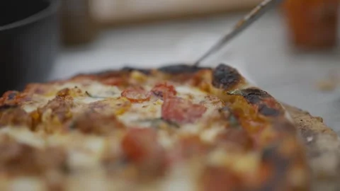 A slice of pizza with a knife on it Video stock 297843764