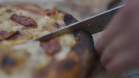 A slice of pizza with a knife in the middle Stock Footage 297843502
