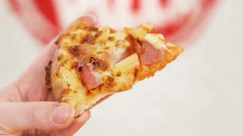 Slice of pizza with pineapple and ham in hand. Stock Footage 265159905