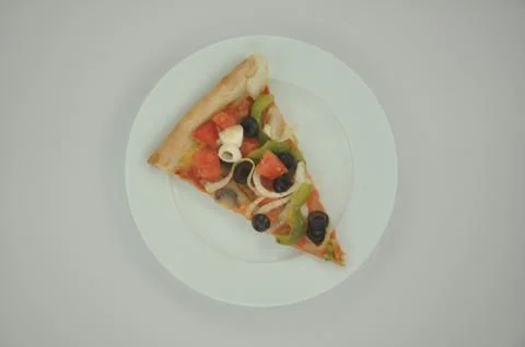 Slice of pizza on plate Foto stock