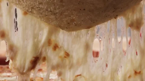 A slice of pizza rises and the cheese stretches Stock Footage 260866993