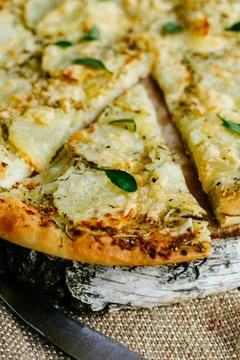 Slice of pizza separated from the main part of the pizza. Stock Photos