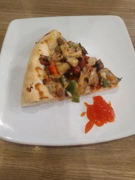 A slice of pizza on the table Stock Photos