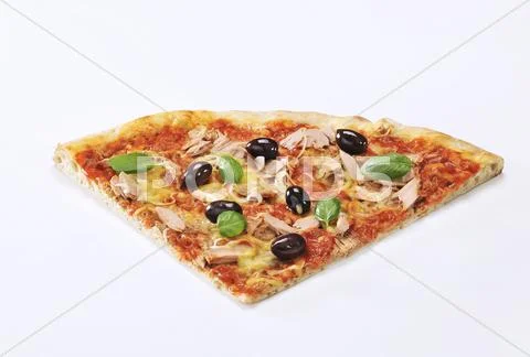 A slice of pizza with tuna, olives and basil Stock Photos