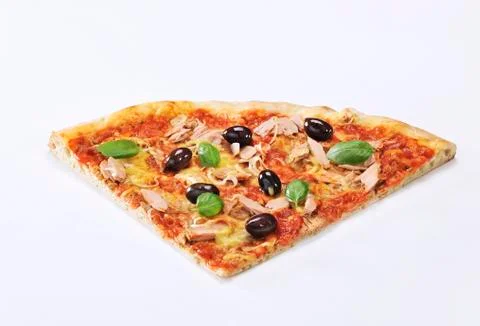 A slice of pizza with tuna, olives and basil Stock Photos