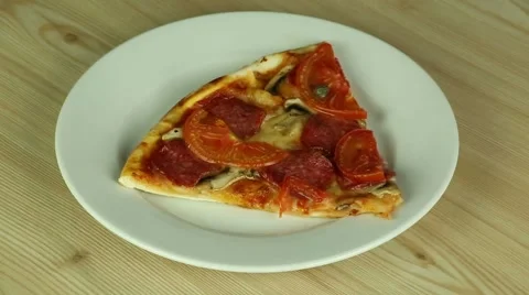 Slice of pizza on a white plate Stock Footage 51726580