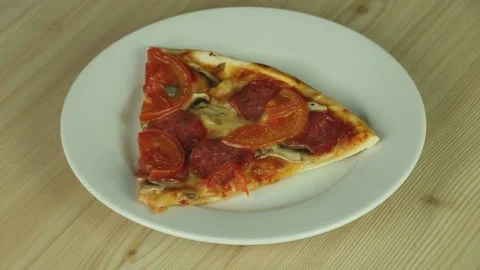Slice of pizza on a white plate Stock Footage 173111569