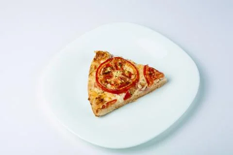 A slice of pizza on a white plate Foto stock