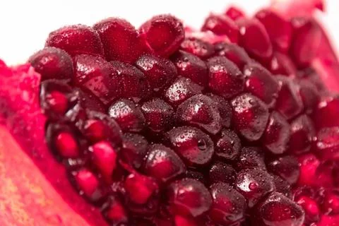 A slice of pomegranate on white background Stock Photos