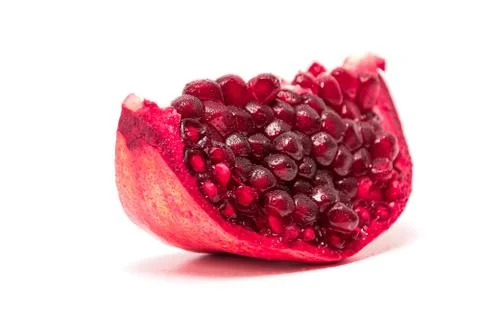 A slice of pomegranate on white background Stock Photos