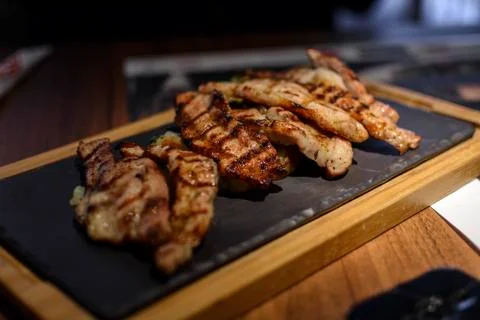 Slice of pork meat cooked in bbq. Stock Photos