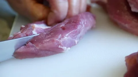 Slice pork meat with a knife Stock Footage 144881859