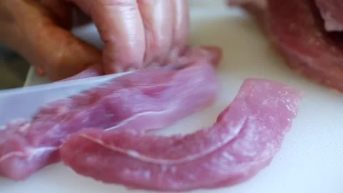 Slice pork meat with a knife Stock Footage 144881873