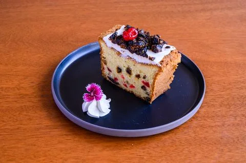 Slice of pound cake with candied fruit sitting on a plate Stock Photos