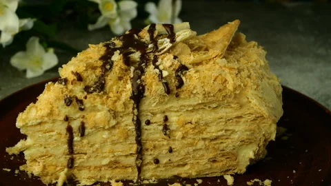 Slice of puff appetizing Napoleon cake is poured on top with chocolate fondant. Stock Footage 131846291