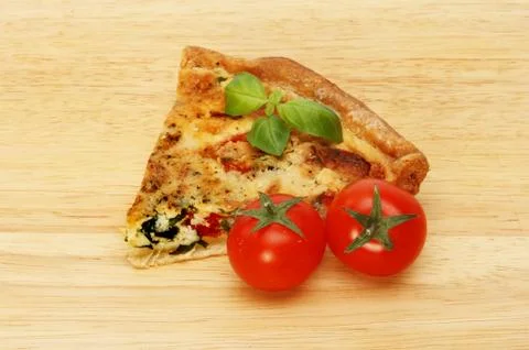 Slice of quiche on a board Stock Photos