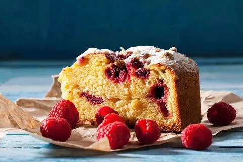 Slice of raspberry and berries cake on paper Stock Photos