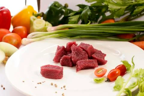 Slice raw ostrich meat with vegetable Stock Photos