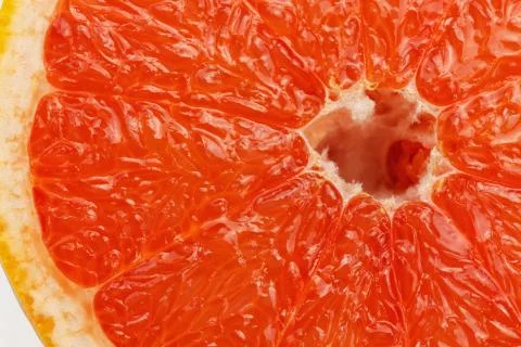 Slice of red grapefruit Stock Photos