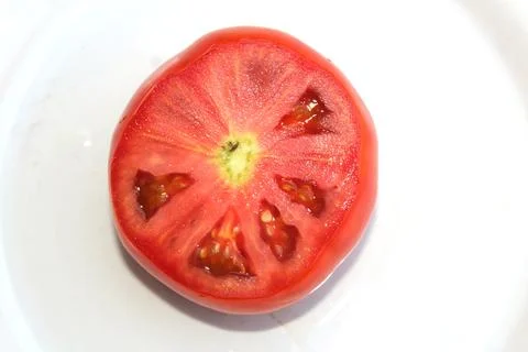 Slice of red tomato Stock Photos