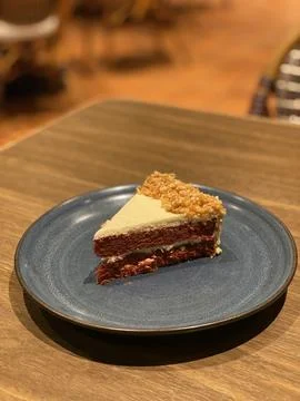 Slice of Red Velvet Soft Cheese Cake with Nut Topping Stock Photos