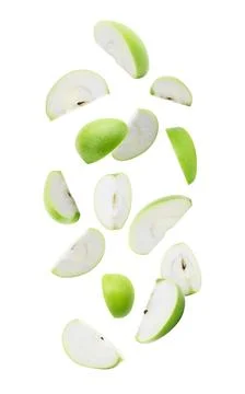 Slice ripe green apple falling isolated on white background with clipping pat Stock Photos