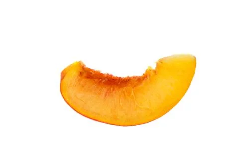 Slice of ripe peach fruit macro on white background Stock Photos